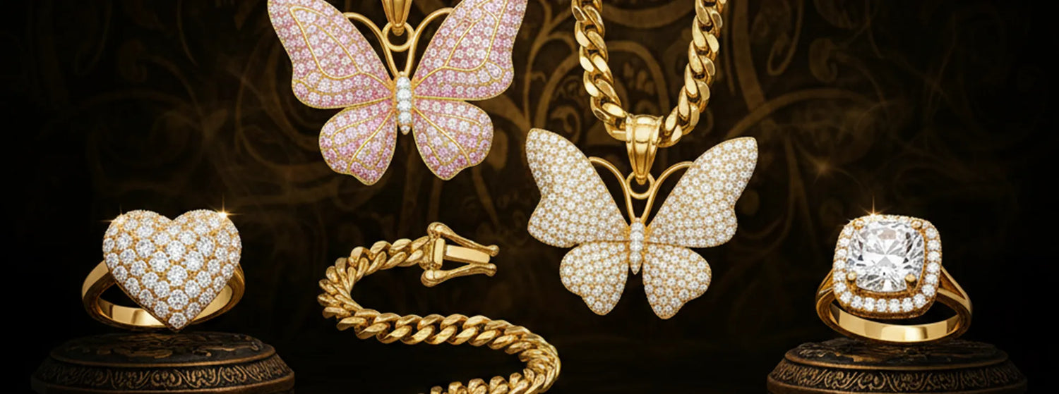 Gold jewelry including butterfly pendants and rings on a dark background